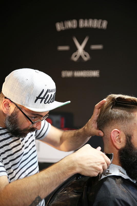 Photo of a man with a beard getting a haircut