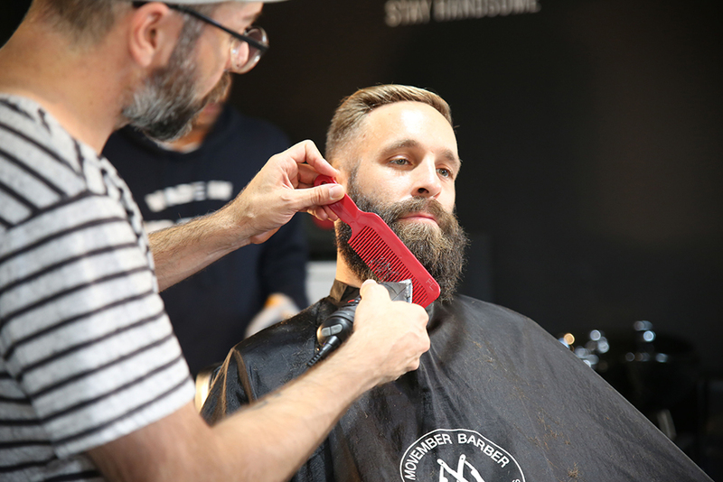 Photo of a man with getting his beard shaped