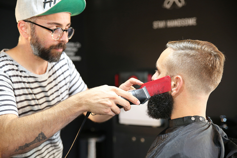 Photo of a man with getting his beard shaped