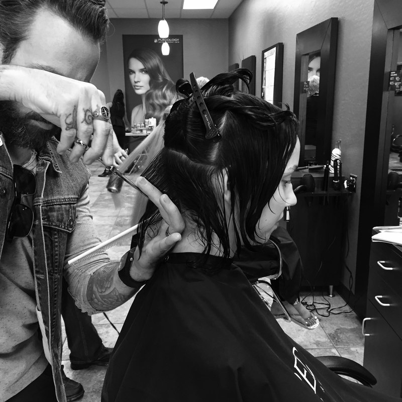 A man cutting hair in the salon