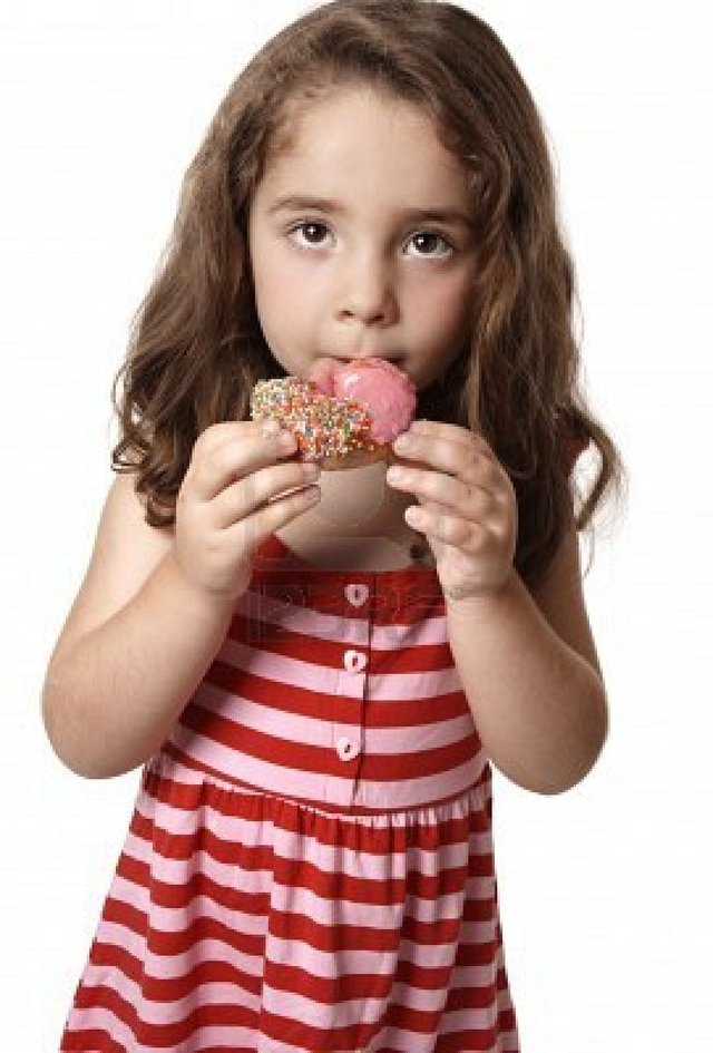 4402615-a-child-eating-an-unhealthy-doughnut-snack