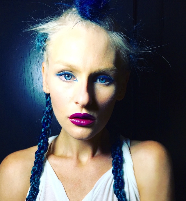 Photo of a model with blue hair weaved into her braids